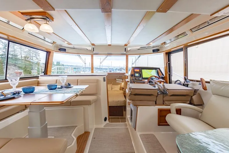 Slide: The Image of Luxurious interior of 2025 Ranger Tugs 43 Command Bridge yacht, featuring elegant seating and navigation area. - 31