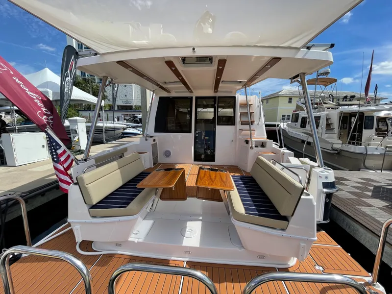 Slide: The Image of 2025 Ranger Tugs 43 Command Bridge yacht with spacious outdoor seating and elegant design. - 4