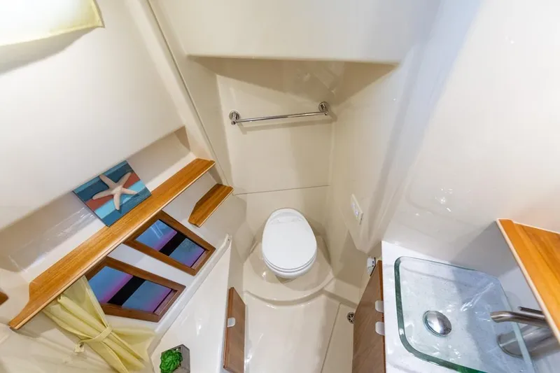 Slide: The Image of 2025 Ranger Tugs 43 Command Bridge bathroom with modern fixtures and nautical decor. - 42