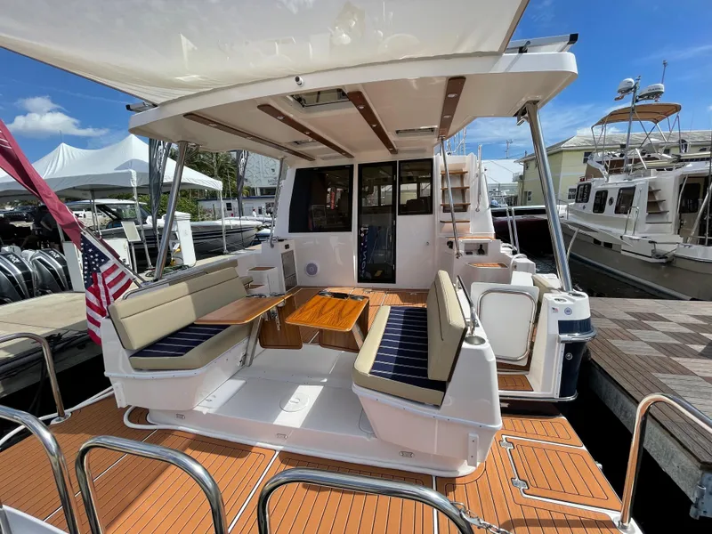 Slide: The Image of 2025 Ranger Tugs 43 Command Bridge yacht with spacious deck and seating area. - 5