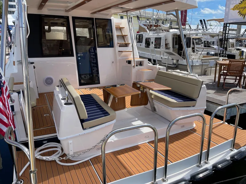Slide: The Image of 2025 Ranger Tugs 43 Command Bridge yacht with spacious deck and seating area. - 7