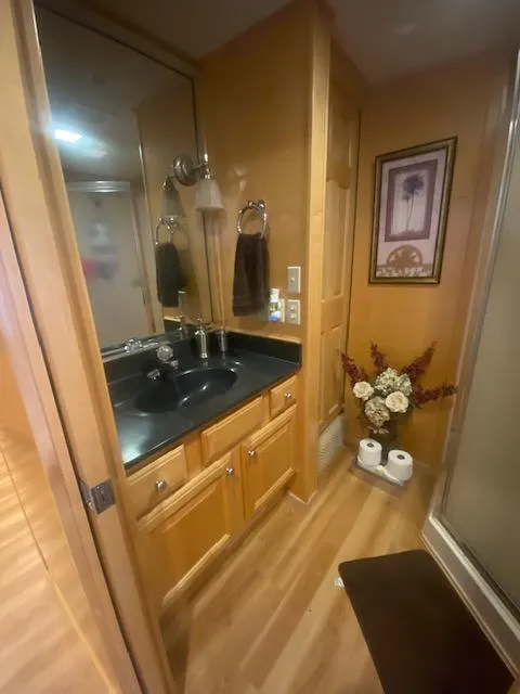 Slide: The Image of Luxurious bathroom in 2000 Sumerset 18x85 houseboat with wood accents and modern fixtures. - 13
