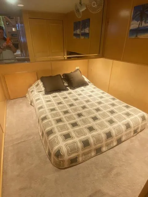 Slide: The Image of Cozy bedroom in 2000 Sumerset 18x85 houseboat with patterned bedding and wooden walls. - 15