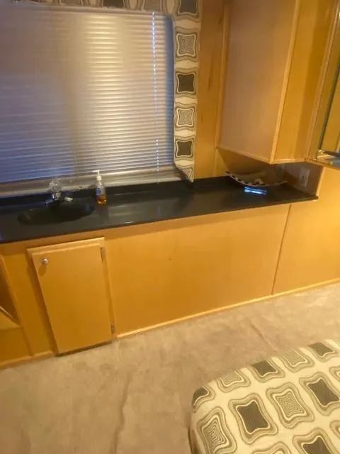 Slide: The Image of Interior of 2000 Sumerset 18x85 houseboat with wooden cabinetry and patterned decor. - 17