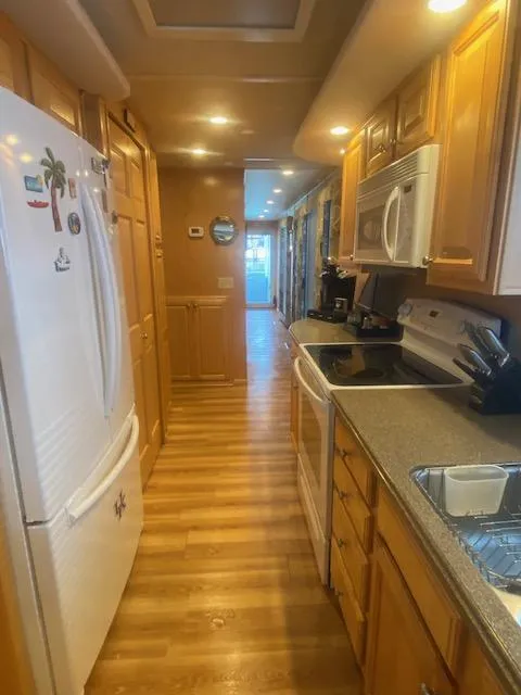 Slide: The Image of Spacious kitchen in 2000 Sumerset 18x85 houseboat with wooden cabinets and modern appliances. - 18