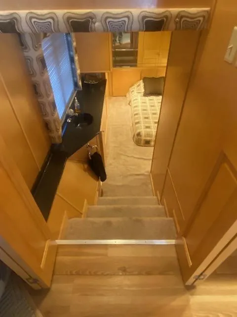 Slide: The Image of Interior of 2000 Sumerset 18x85 Houseboat with stairs leading to cozy bedroom. - 20