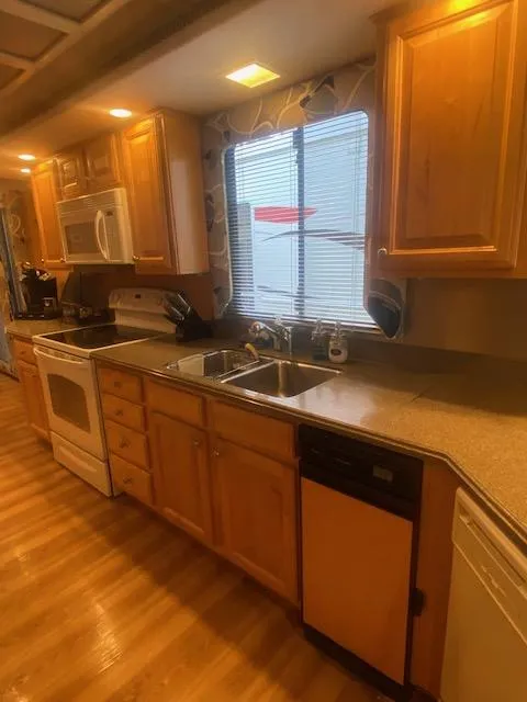 Slide: The Image of Spacious kitchen in 2000 Sumerset 18x85 houseboat with wooden cabinets and modern appliances. - 21