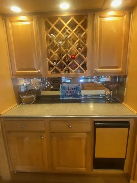 Slide: The Image of Wooden kitchen cabinet with wine rack in 2000 Sumerset 18x85 Houseboat. - 22