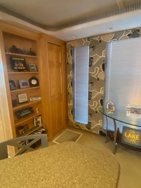 Slide: The Image of Interior of 2000 Sumerset 18x85 Houseboat with cozy decor and shelving. - 23