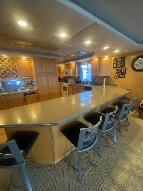 Slide: The Image of Luxurious 2000 Sumerset 18x85 houseboat kitchen with bar seating and modern amenities. - 24