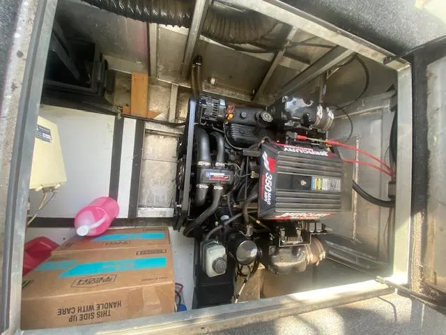 Slide: The Image of Engine compartment of a 2000 Sumerset 18x85 Houseboat with visible MerCruiser engine. - 25