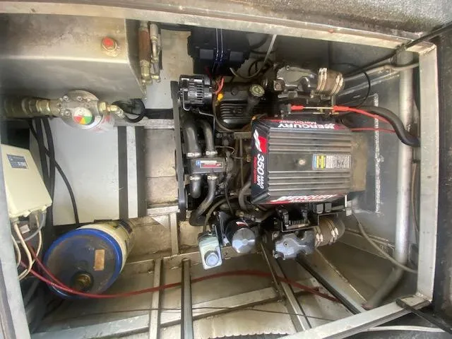 Slide: The Image of Engine compartment of a 2000 Sumerset 18x85 Houseboat, featuring a MerCruiser 350 engine. - 26