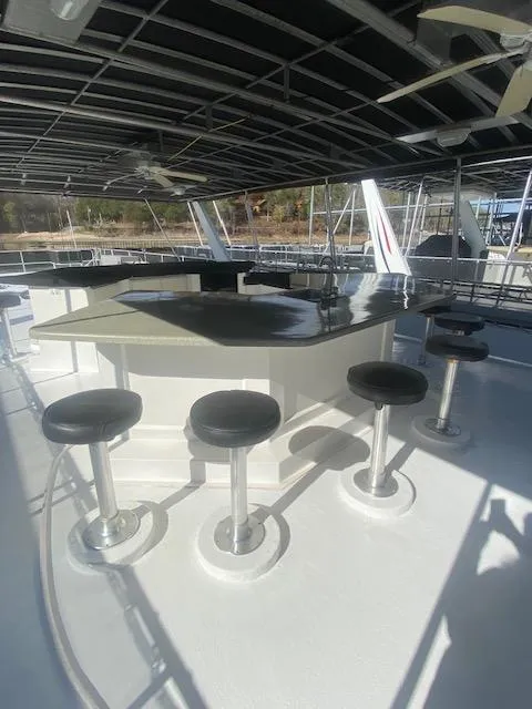 Slide: The Image of Outdoor bar area on 2000 Sumerset 18x85 houseboat with stools and canopy. - 30