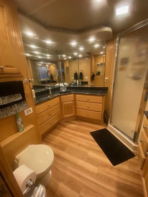 Slide: The Image of Luxurious bathroom in 2000 Sumerset 18x85 houseboat with wood flooring and modern fixtures. - 5