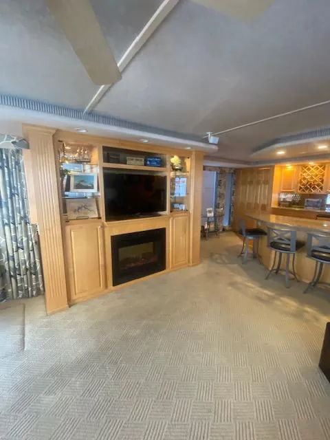 Slide: The Image of Interior of 2000 Sumerset 18x85 houseboat with entertainment center and bar area. - 6