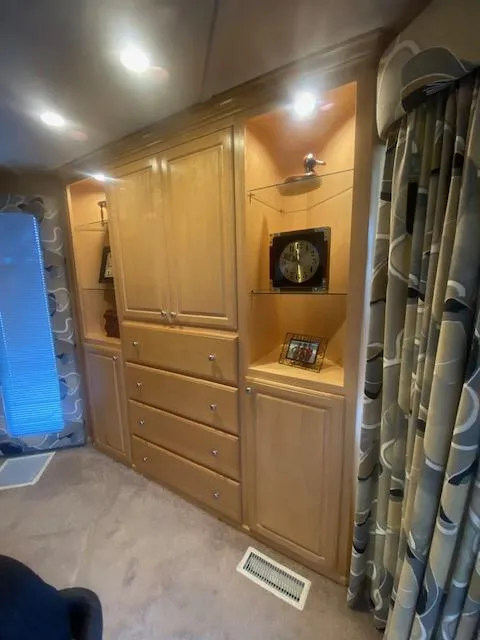 Slide: The Image of Sumerset 18x85 Houseboat 2000 interior with wooden cabinets and decorative shelving. - 7