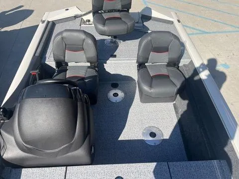 Slide: The Image of 2024 Tracker Pro Team 175 TXW boat interior with seating and console. - 12