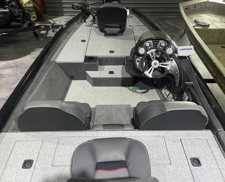 Slide: The Image of 2024 Tracker Pro Team 175 TXW boat interior with steering console and seating. - 13