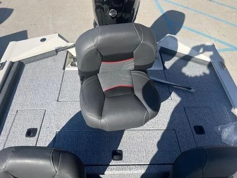 Slide: The Image of 2024 Tracker Pro Team 175 TXW boat seat on gray deck. - 15