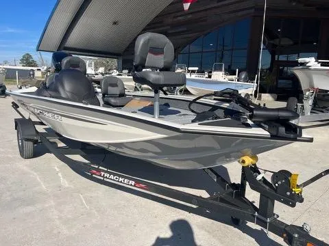 Slide: The Image of 2024 Tracker Pro Team 175 TXW fishing boat on trailer, parked outdoors. - 2
