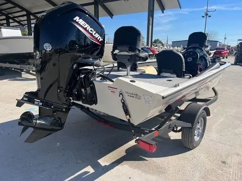 Slide: The Image of 2024 Tracker Pro Team 175 TXW boat with Mercury engine, parked outdoors. - 4