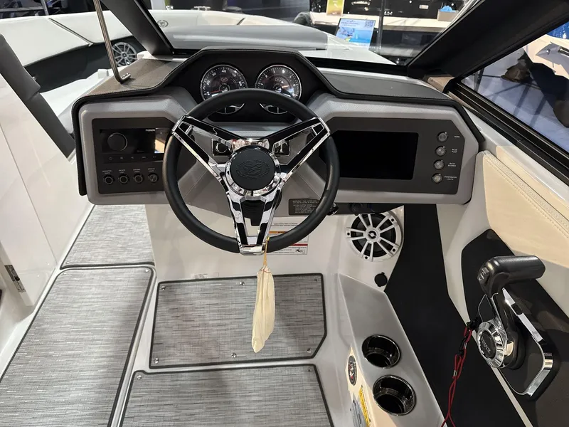 Slide: The Image of 2025 Cobalt CS22 boat dashboard with steering wheel and control panel. - 11