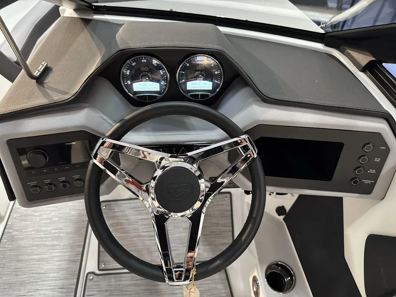 Slide: The Image of 2025 Cobalt CS22 boat dashboard with modern steering wheel and instrument panel. - 12