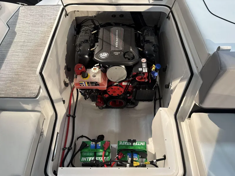 Slide: The Image of 2025 Cobalt CS22 boat engine compartment with visible Interstate battery and components. - 18