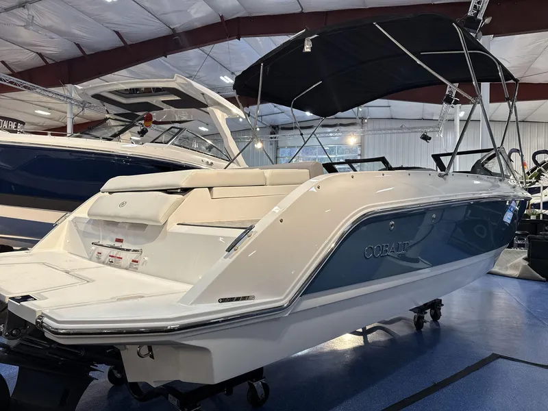 Slide: The Image of 2025 Cobalt CS22 boat displayed indoors with sleek design and black canopy. - 4