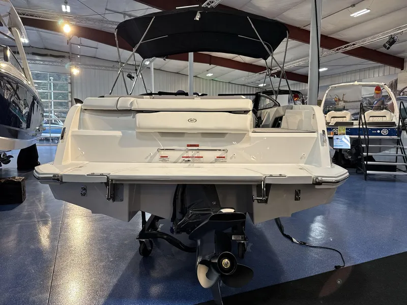 Slide: The Image of 2025 Cobalt CS22 boat displayed in a showroom, rear view with propeller. - 5