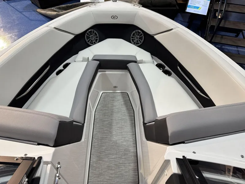 Slide: The Image of 2025 Cobalt CS22 boat interior with gray and white seating, cup holders, and speakers. - 8