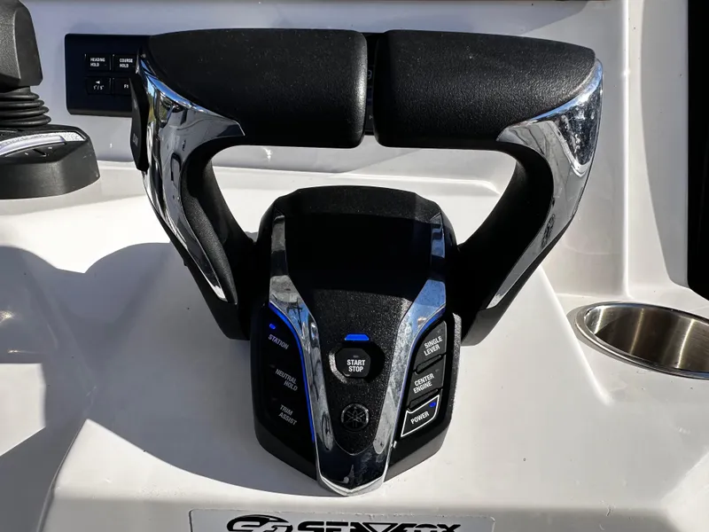 Slide: The Image of 2025 Sea Fox 328 Commander boat throttle control with chrome accents and control buttons. - 14