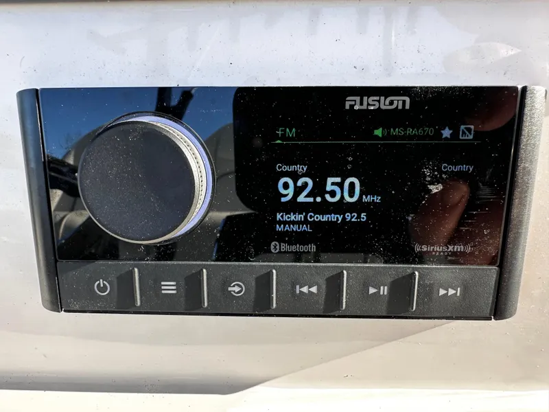 Slide: The Image of Fusion radio display on Sea Fox 328 Commander, tuned to 92.5 MHz, 2025 model. - 16