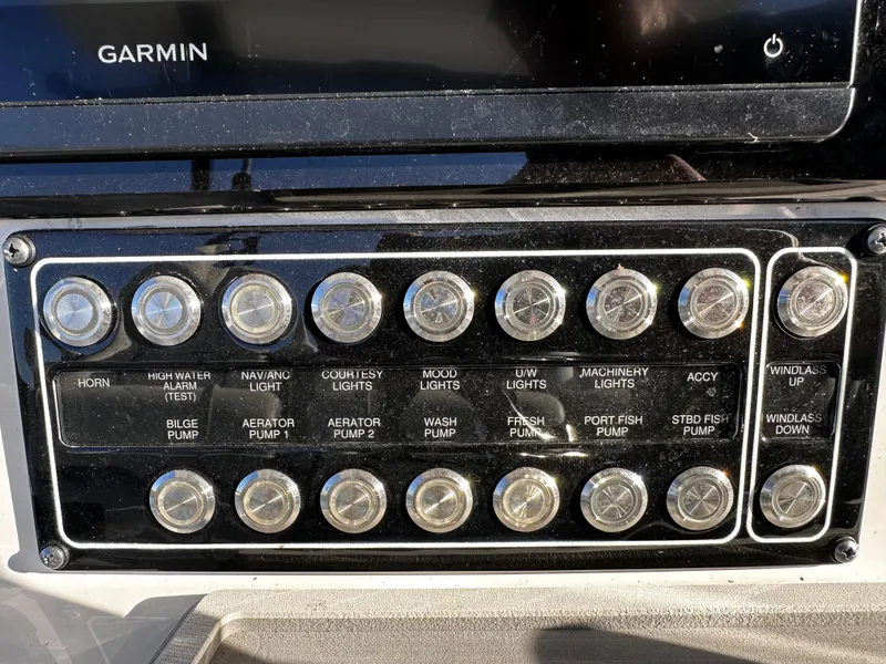 Slide: The Image of Control panel of 2025 Sea Fox 328 Commander boat with labeled switches. - 17