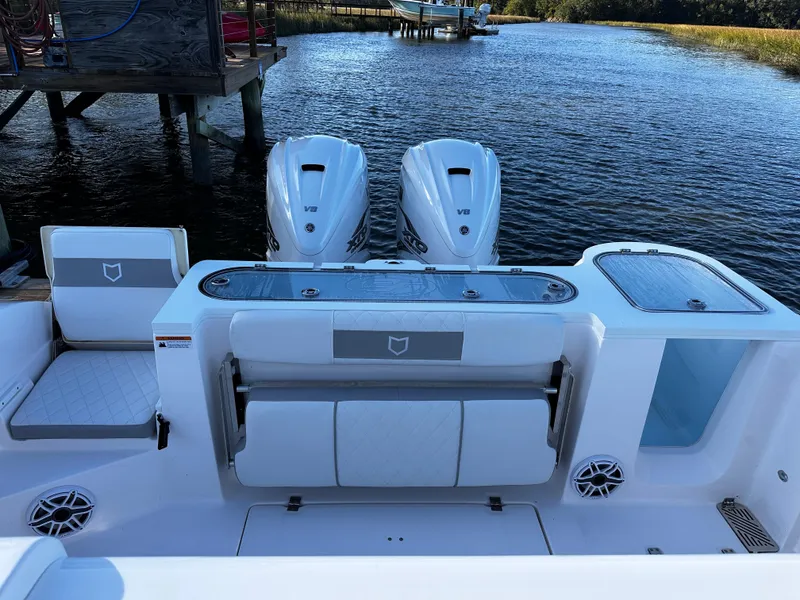 Slide: The Image of 2025 Sea Fox 328 Commander boat with dual engines on a serene waterway. - 24