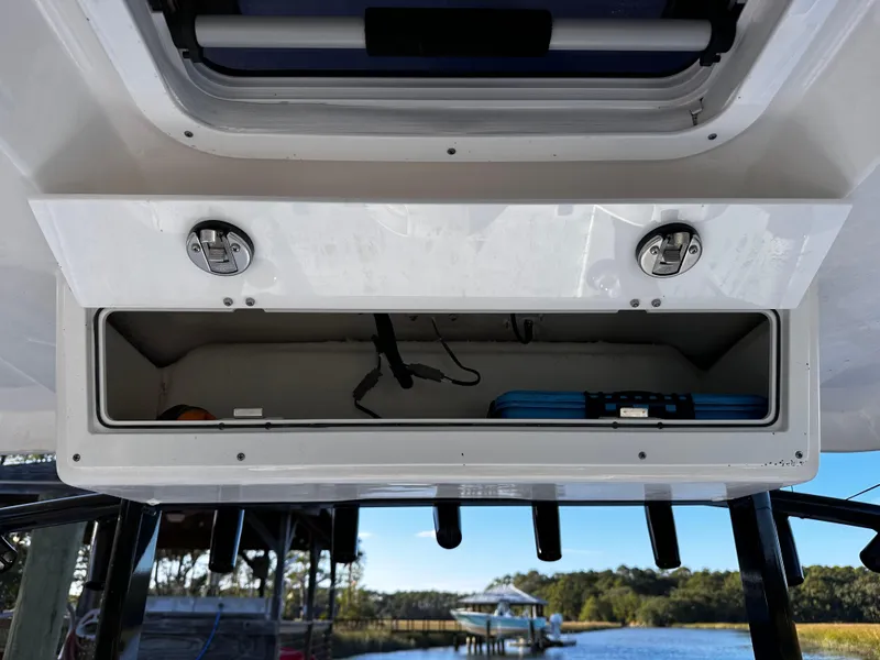 Slide: The Image of 2025 Sea Fox 328 Commander storage compartment with open hatch, showcasing interior details. - 34