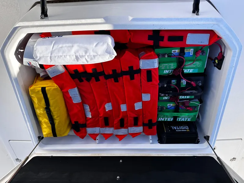 Slide: The Image of Storage compartment of 2025 Sea Fox 328 Commander with life jackets and batteries. - 38