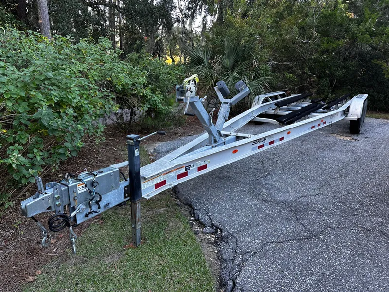 Slide: The Image of Boat trailer for 2025 Sea Fox 328 Commander on a paved road near greenery. - 41