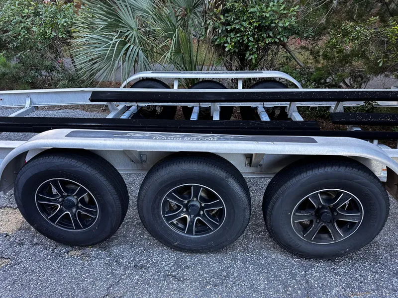 Slide: The Image of Triple-axle trailer for 2025 Sea Fox 328 Commander boat, parked on gravel. - 42