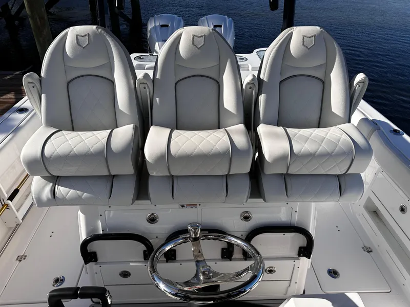 Slide: The Image of 2025 Sea Fox 328 Commander boat seats and steering wheel, luxury marine interior. - 7