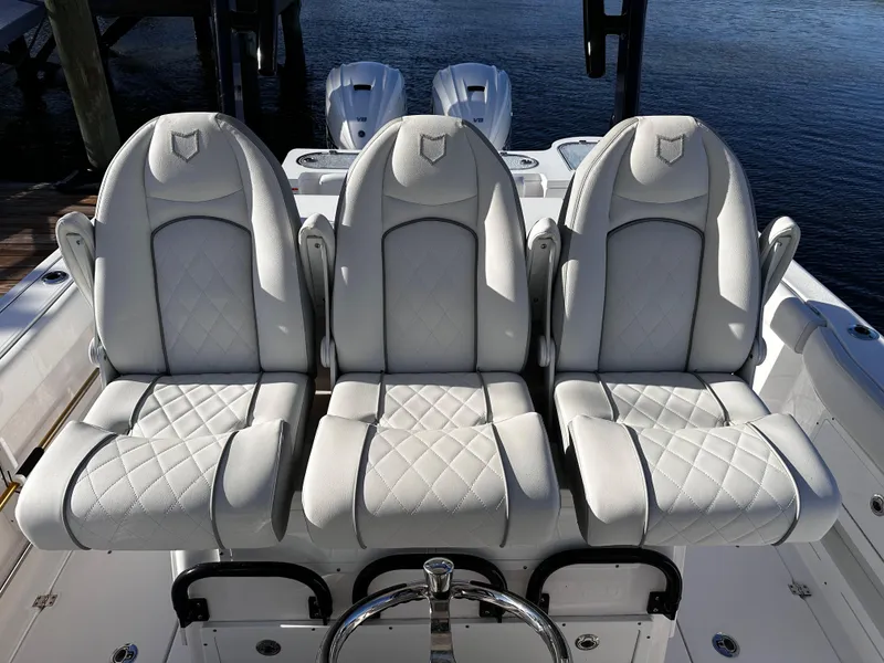 Slide: The Image of 2025 Sea Fox 328 Commander boat with three luxurious white seats. - 8