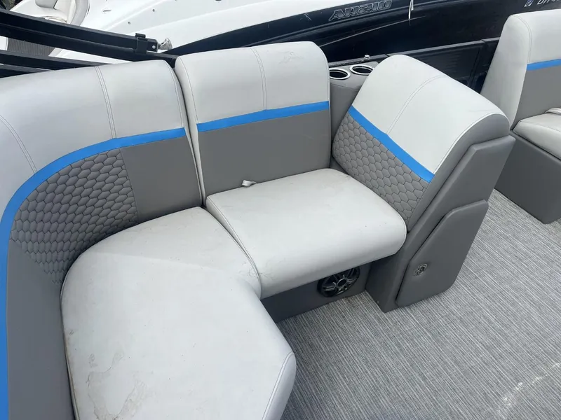 Slide: The Image of 2023 Qwest Lanai 818 boat interior with gray and blue seating. - 3