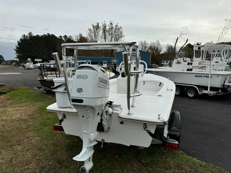 Slide: The Image of 2025 Delta Boatworks Delta 18 with Suzuki outboard motor, parked on grass. - 3