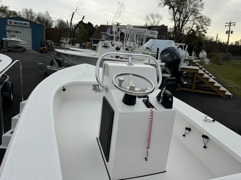 Slide: The Image of Delta 18 boat by Delta Boatworks, 2025 model, with steering console, parked outdoors. - 4