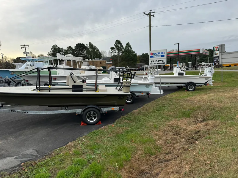 Slide: The Image of 2025 Delta Boatworks Delta 18 boats displayed outdoors on trailers. - 9
