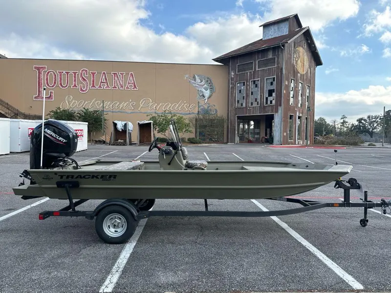 Slide: The Image of 2025 Tracker Grizzly 1860 CC boat on trailer in parking lot, Louisiana background. - 2