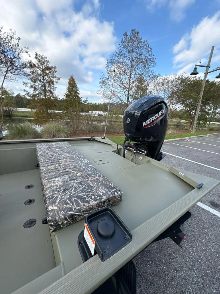 Slide: The Image of 2025 Tracker Grizzly 1860 CC boat with Mercury engine in scenic outdoor setting. - 6