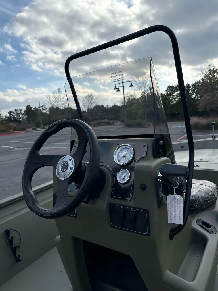 Slide: The Image of 2025 Tracker Grizzly 1860 CC boat console with steering wheel and gauges. - 7