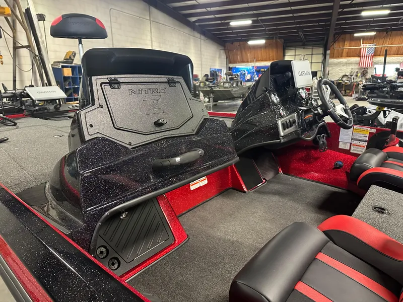 Slide: The Image of 2025 Nitro Z18 Pro boat interior with red and black seating, steering console, and storage compartments. - 12
