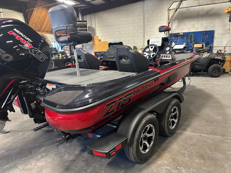 Slide: The Image of 2025 Nitro Z18 Pro boat in a garage, featuring a Mercury engine and dual-axle trailer. - 3